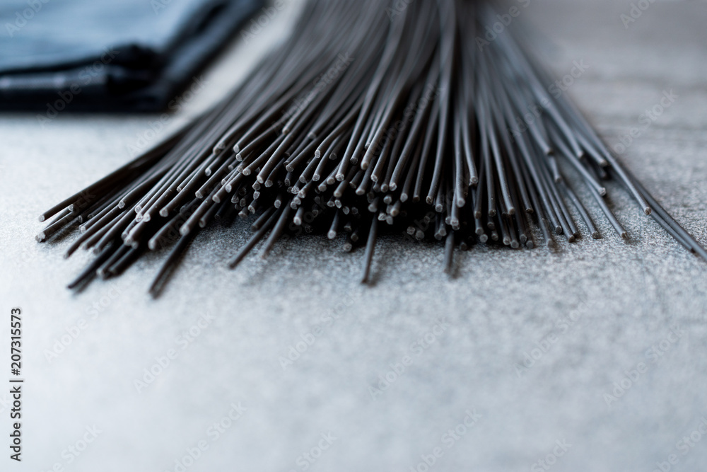 Raw Black Spaghetti Pasta Flavored with Squid ink or Cuttlefish. Raw Black Spaghetti Pasta Flavored with Squid ink or Cuttlefish.