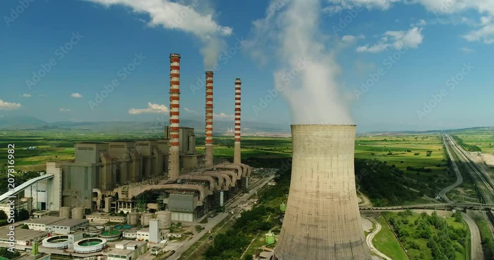 Flying over the plant producing electrical energy with large pipes at Kozani in northern Greece. Aerial shot Flying over the plant producing electrical energy with large pipes at Kozani in northern Greece. Aerial shot