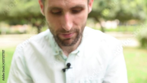 Someone takes a tiny yellow toy from a handsome brunnete young man in light green shirt, who gasps in surprise