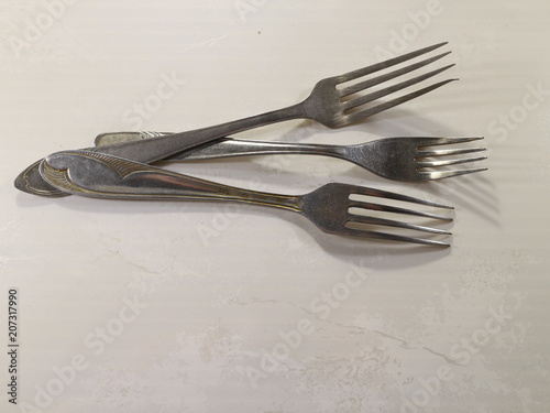 several table forks on the table