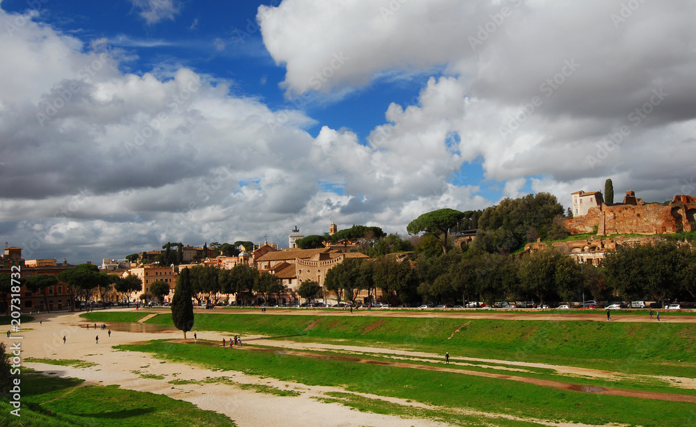 View of Circus Maximus, Palatine Hill ruins and Capitoline Hill monuments with beautiful clouds just after rain, in the historic center of Rome