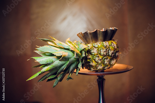 Stylish hookah with the aroma pineapple for relax.Pineapple shisha.Hookah lounge photo