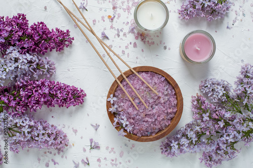 Lilac bath salt and incense sticks with lilac flowers top view