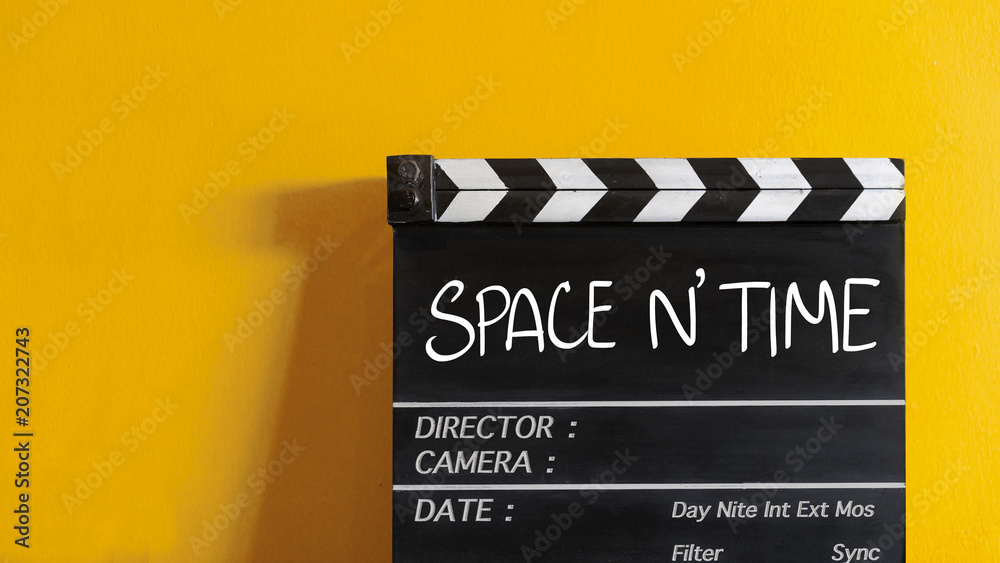 space and time  text title on wooden clapper board