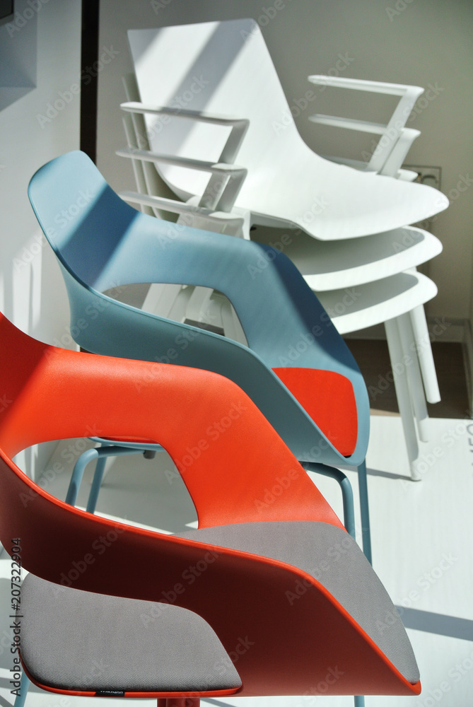  the white and colored plastic chairs