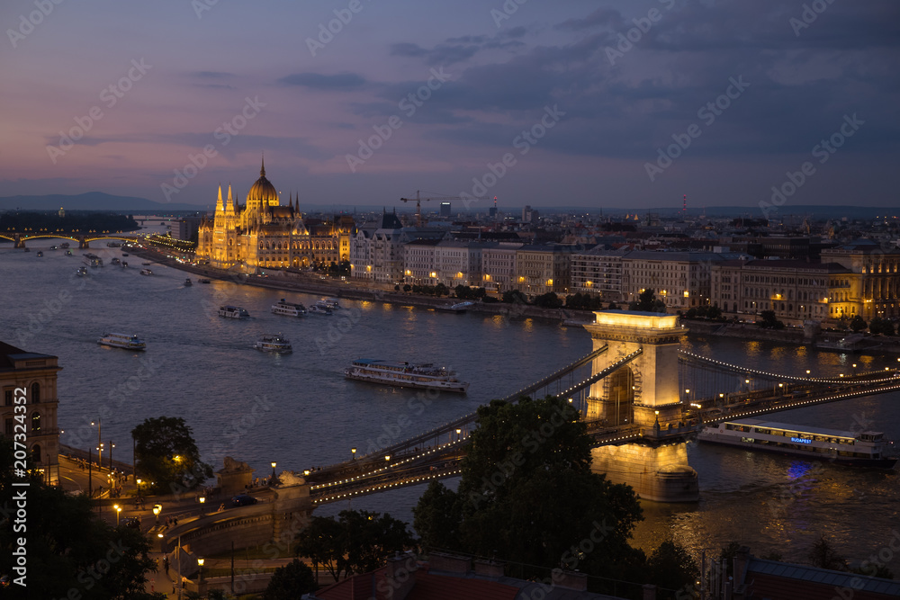Beautiful view on the Danube promenade, Parliament and chain bridge at dusk, Budapest 