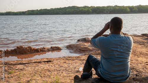 black young man overlooking lake