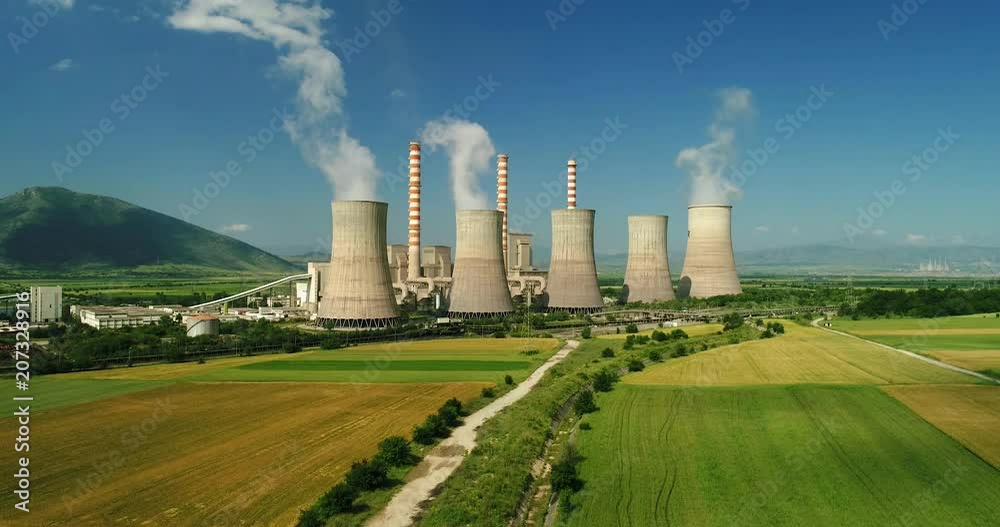 Flying over the plant producing electrical energy with large pipes at Kozani in northern Greece. Aerial shot Flying over the plant producing electrical energy with large pipes at Kozani in northern Greece. Aerial shot