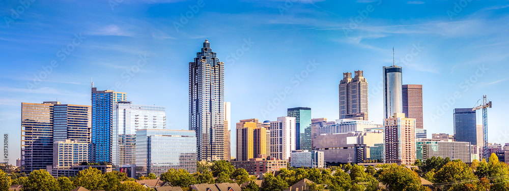 Downtown Atlanta Skyline showing several prominent buildings and hotels under a blue sky.