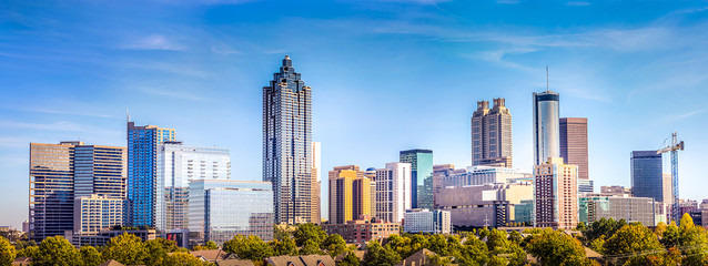 Downtown Atlanta Skyline showing several prominent buildings and hotels under a blue sky.