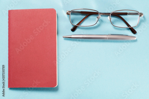 Glasses, pen and notebook o...