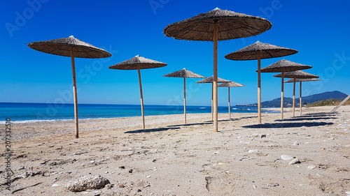 sea beach umbrellas in preveza kanali greece photo