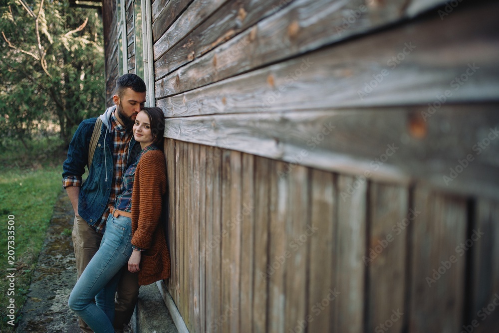 couple near old wooden house