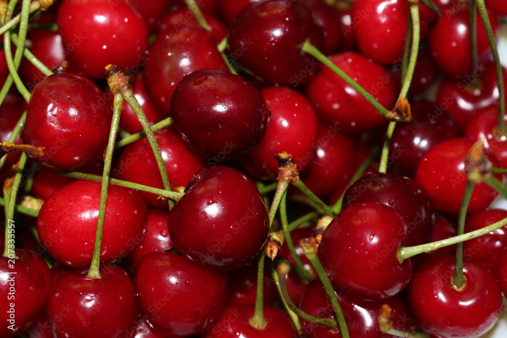 Red ripe cherry lies on a plate Red ripe cherry lies on a plate