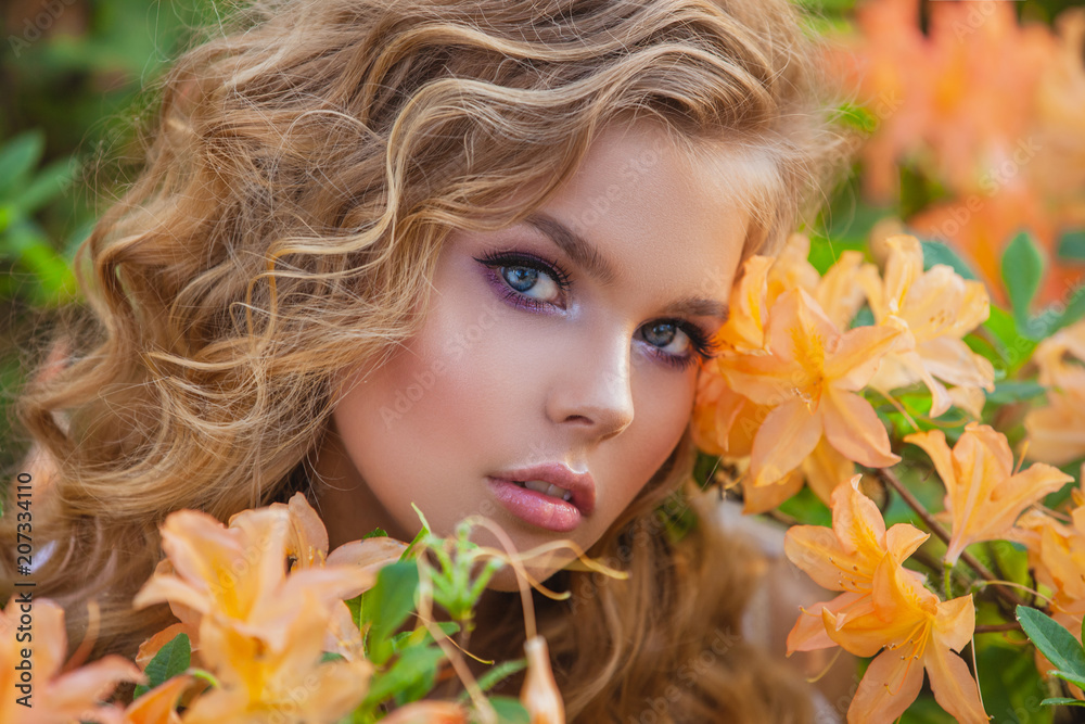 Portrait of a beautiful girl in a blooming garden. Hairstyle and make-up. Portrait of a beautiful girl in a blooming garden. Hairstyle and make-up.