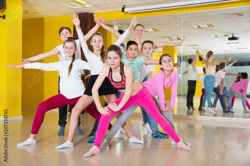 Children having fun in choreography class, posing with trainer