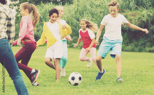 children are jogning and playing football © JackF