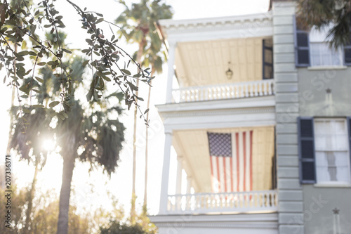 American flag hanging from southern porch in Charleston, South Carolina photo