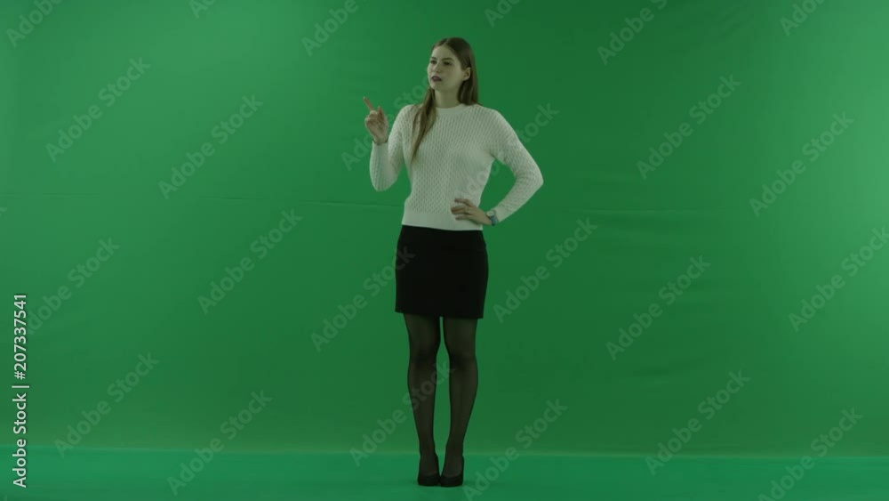 young woman scrolls the screen and considers something on green screen young woman scrolls the screen and considers something on green screen