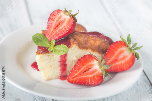Slice of cheesecake with fresh strawberries
