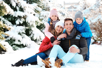 Portrait of happy family in winter park