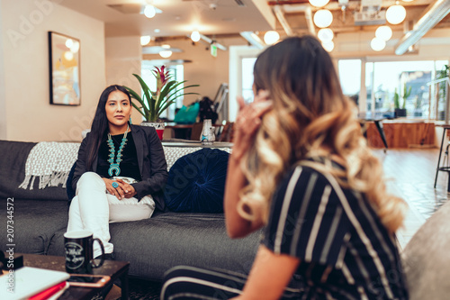 Businesswomen talking in modern office photo