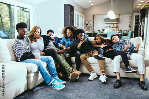 Group of happy friends enjoying at home photo