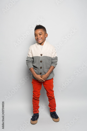 Smiling boy standing against white background