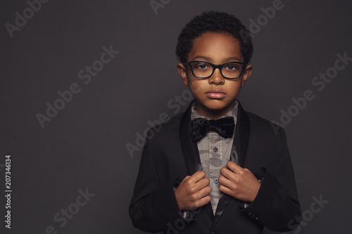 Portrait of boy posing against purple background photo