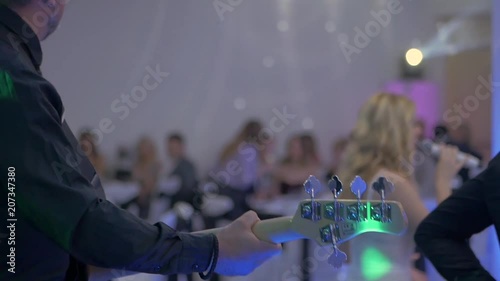 Bass player on wedding party indoor