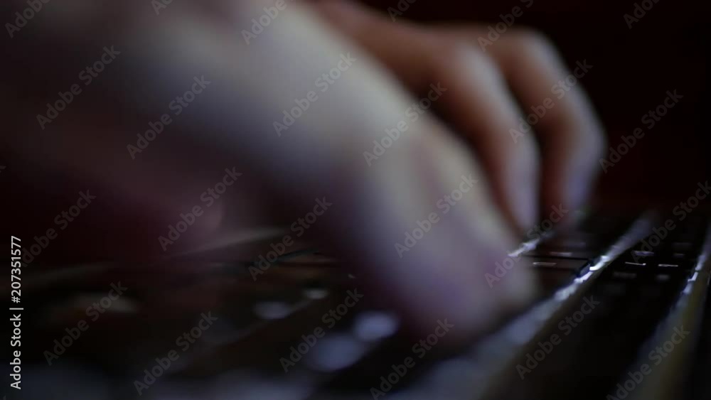 Backlit laptop keyboard typing fast at night - cyber concept Backlit laptop keyboard typing fast at night - cyber concept