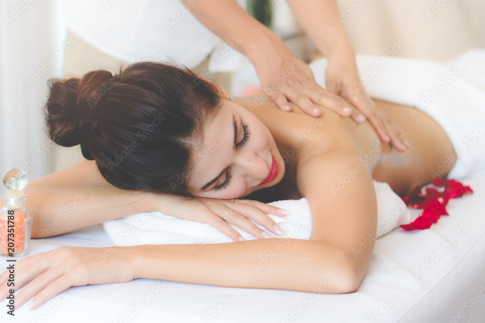 Beautiful woman lying down on the bed relax in spa salon with salt massage. Beautiful woman lying down on the bed relax in spa salon with salt massage.