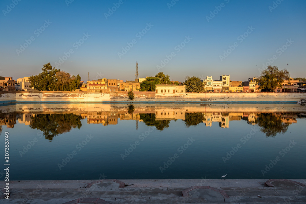 Naklejka premium Waterfront Reflection of Houses in Bikaner India 