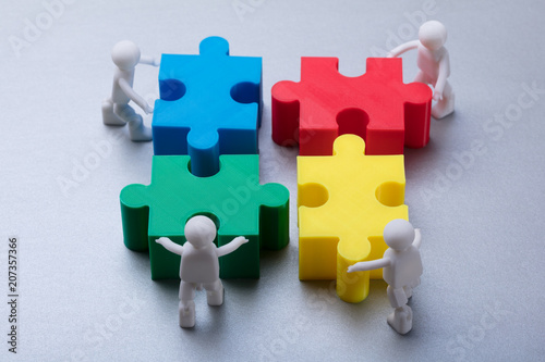 Human Figures Solving Jigsaw Puzzle