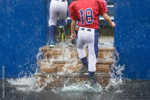 Rainy soggy day for football player walking in stands photo