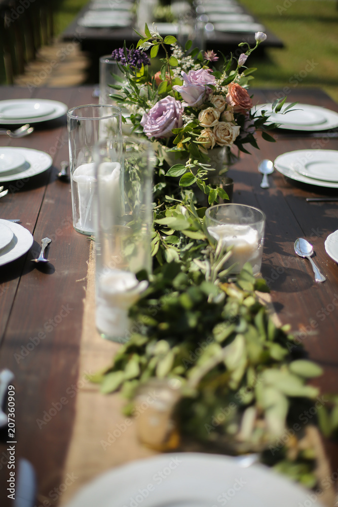 Rustic Wedding Decor Pink, Peach, Purple, and Green Floral Centerpieces on  a Wooden Farm Table Stock Photo | Adobe Stock
