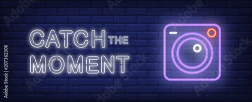 Catch the moment vector illustration in neon style. Text and camera on brick wall background. Night bright advertising design, banner, sign. Photography concept