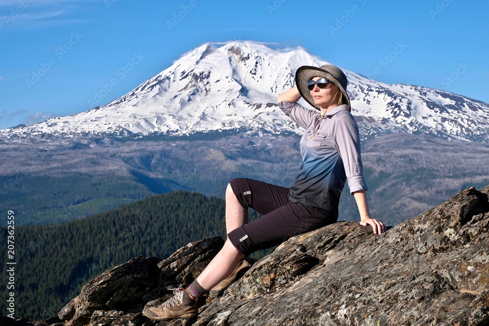Vacation travel in Oregon. Middle age woman relaxing on mountain top by glacier on Mount Adams.  Portland. Oregon. United States of America.