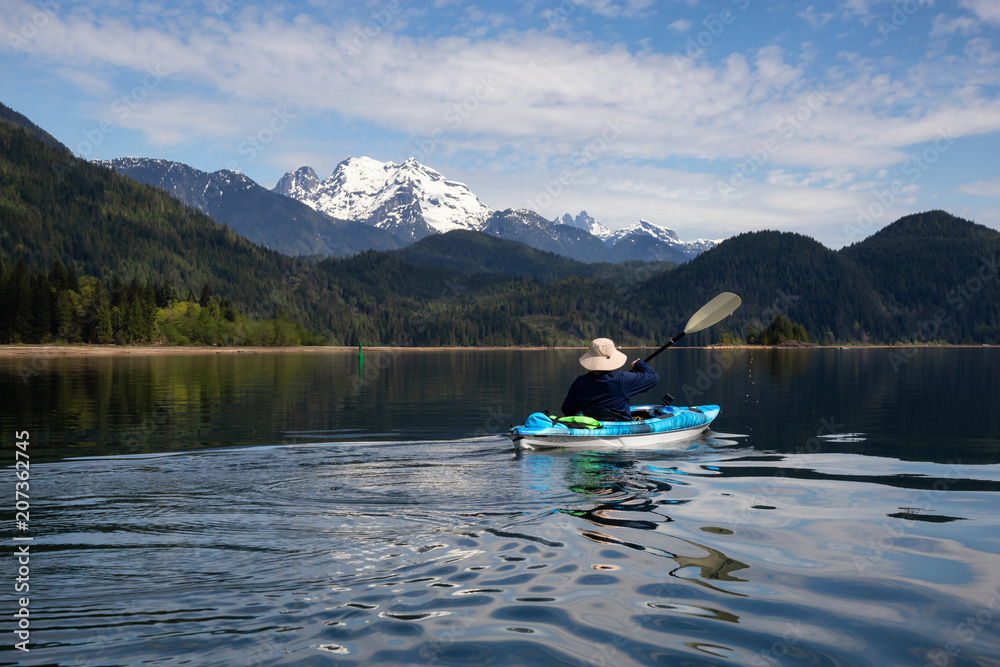 Kayaking during a vibrant morning surrounded by the Canadian Mountain Landscape. Taken in Stave Lake, East of Vancouver, British Columbia, Canada. Concept: Adventure, vacation, holiday Kayaking during a vibrant morning surrounded by the Canadian Mountain Landscape. Taken in Stave Lake, East of Vancouver, British Columbia, Canada. Concept: Adventure, vacation, holiday