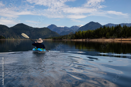 Kayaking during a vibrant morning surrounded by the Canadian Mountain Landscape. Taken in Stave Lake, East of Vancouver, British Columbia, Canada. Concept: Adventure, vacation, holiday