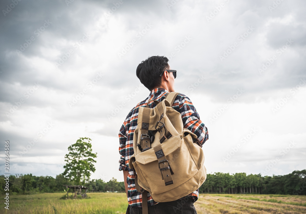 A man travel outdoor nature with storm cloudy background.