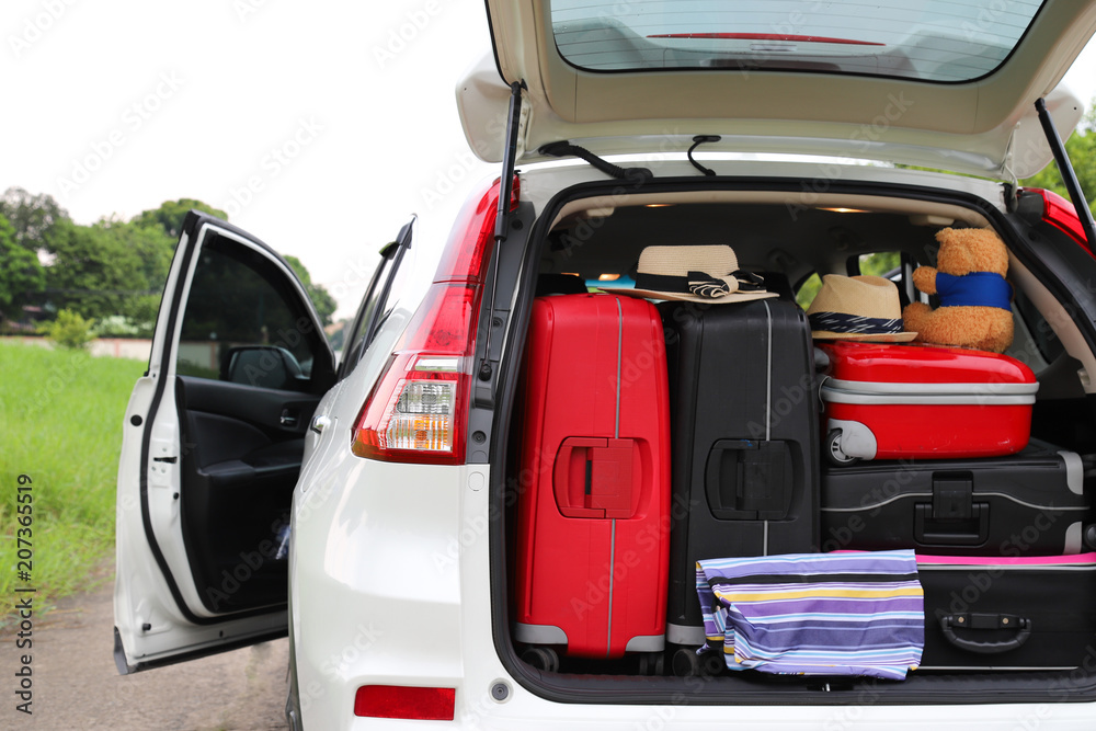 Closeup of rear side of white car carry suitcases and other things for lovely family holiday in summer. Closeup of rear side of white car carry suitcases and other things for lovely family holiday in summer.
