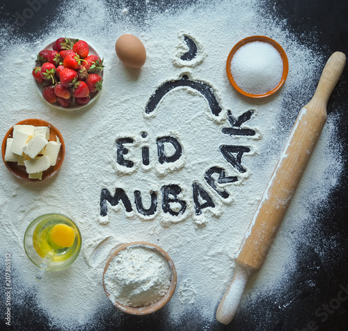 Eid Mubarak - Islamic holiday welcome phrase " happy holiday", greeting reserved. Arabic cuisine background.
