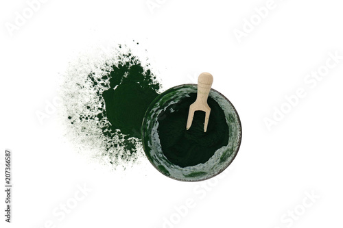 Algae spirulina.Spirulina powder in a ceramic green cup with a wooden scoop on a white background.Super food