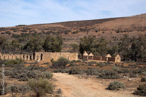 Kanyaka South Australia, arid landscape with abandoned shearing shed and quarters in distance photo