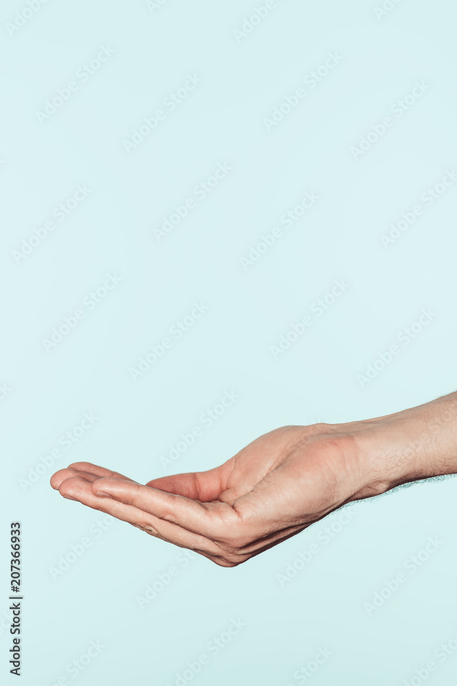 cropped shot of man gesturing by hand isolated on blue background cropped shot of man gesturing by hand isolated on blue background