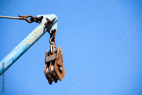 Old metal pulley with blur sky background and text space