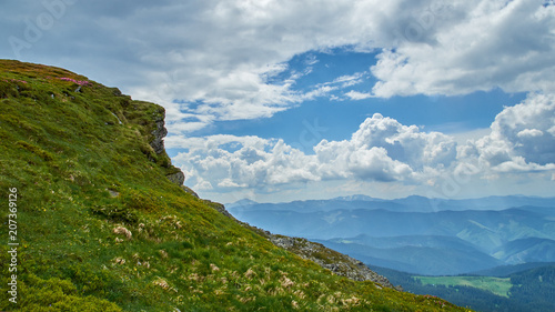 A big green hill in Carpathian mountains in the summer. Mountains landscape background.