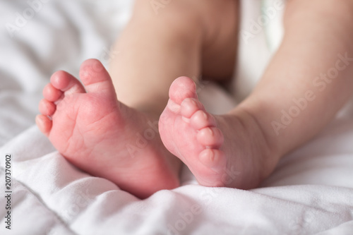 Beautiful image of the feet of a newborn baby on a white blanket