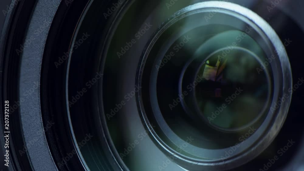 Video camera lens close up, camcorder zooming in